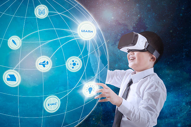 istock Schoolboy wearing virtual reality glasses 611071890