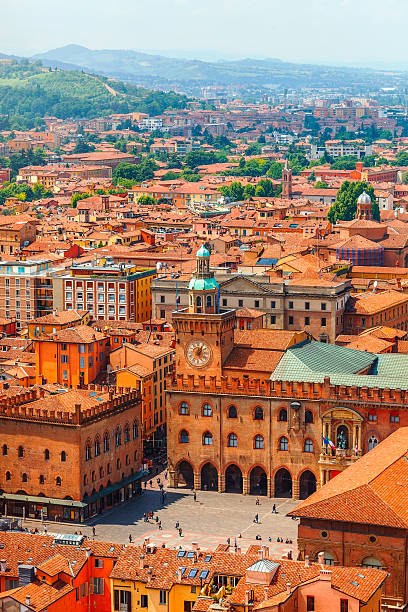 Italy Piazza Maggiore in Bologna old town Italy Piazza Maggiore in Bologna old town tower of hall with big clock and blue sky on background. Antique buildings terracotta galleries bologna photos stock pictures, royalty-free photos & images