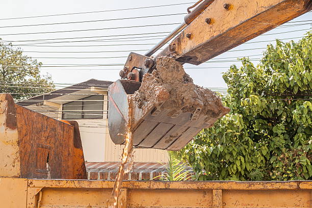 istock Excavator working, machine loading soil or sand into truck body, 611073584