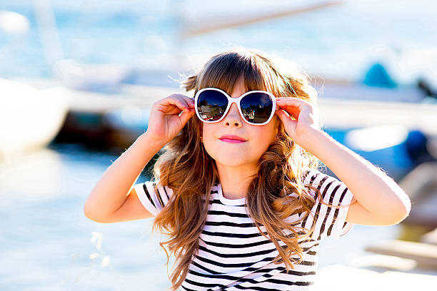 istock young girl sitting on the dock 611073884