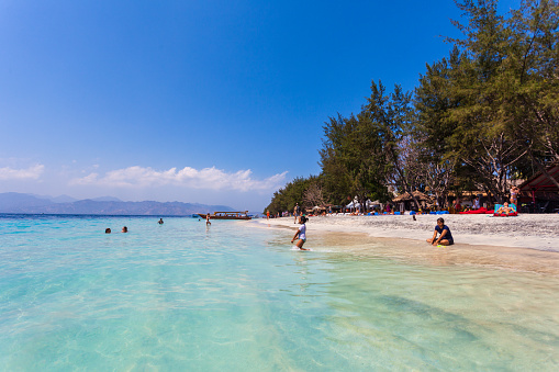 Lombok, Indonesia - September 16, 2012: Tourists enjoying the beach in the Gili Islands in Lombok, Indonesia.