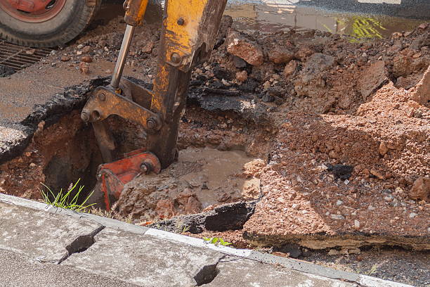 istock Excavator working on the Repair of pipe water 611073940