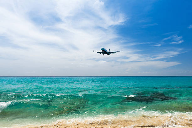 istock airplane landing over the sea 611074730