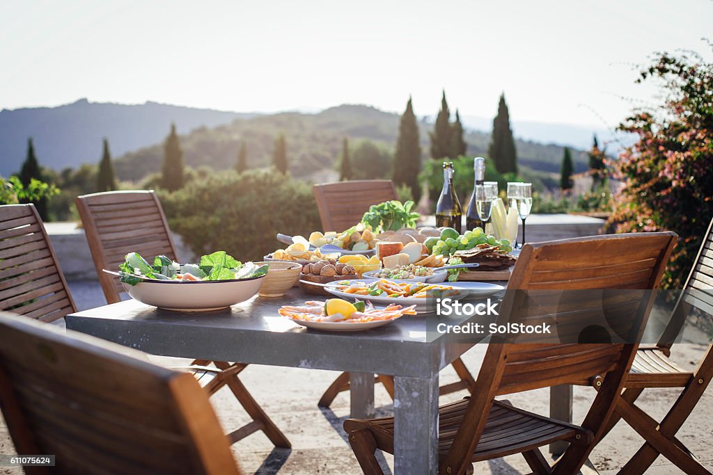 Alfesco Mediterranean Meal A horizontal image of a typical outdoor Mediterranean meal, there is a beautiful landscape of Tuscany, Italy, in the background. There are no people in the shot. Mediterranean Food Stock Photo