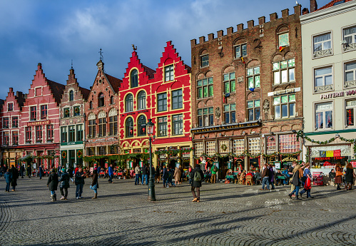 A general view of the historic and touristic city of Bruges in Belgium in summer from the Spiegelrei Canal and Jan Van Eyck Square with historic houses.