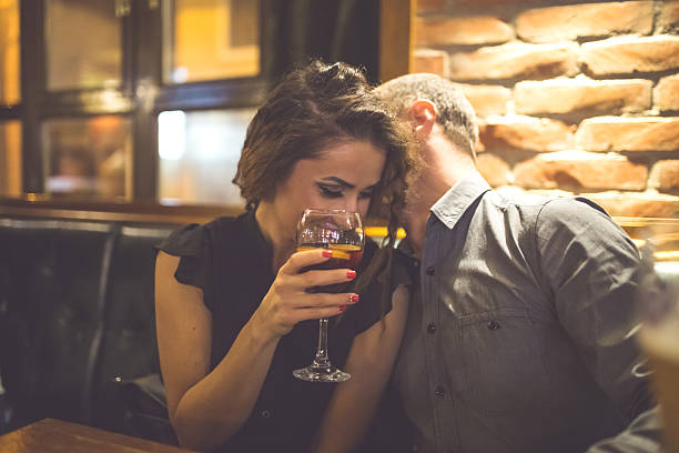 istock Couple Enjoying Night Out At Cocktail Bar 611076400