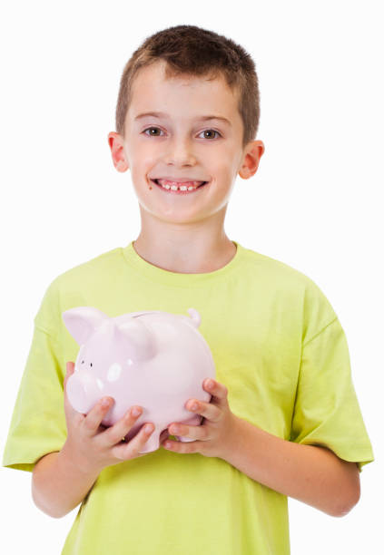 istock Boy with piggy bank 611076656