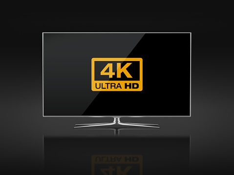 UHD 4K Smart Tv standing on black background. Front view. There is 4K Logo on the display. Clipping path is included.