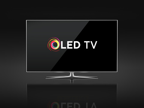 UHD 4K Smart Tv standing on black background. Front view. There is OLED TV Logo on the display. Clipping path is included.