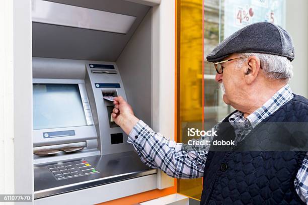 Elderly Man Inserting Credit Card To Atm Stock Photo - Download Image Now - Senior Adult, Retirement, ATM