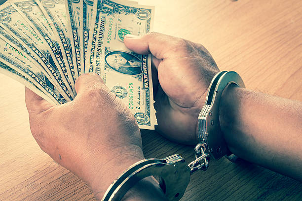 istock Hand young man in handcuffed hold money 611078100