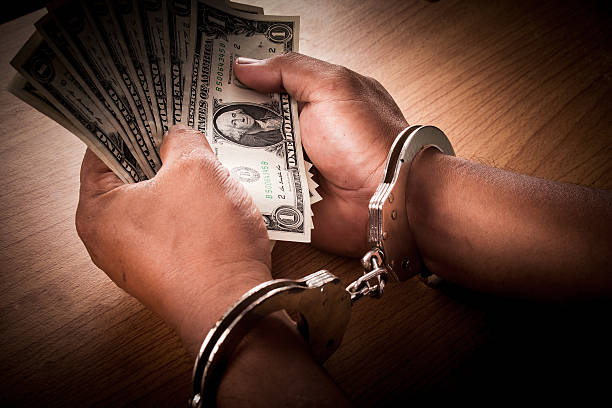 istock Hand young man in handcuffed hold money 611078858