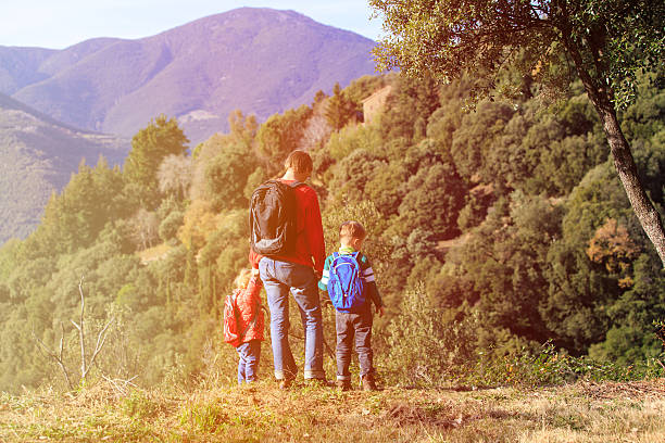 istock father with two kids travel in mountains 611079568