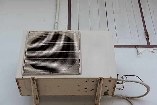 istock Old air compressors is located behind the wall home. 611080132