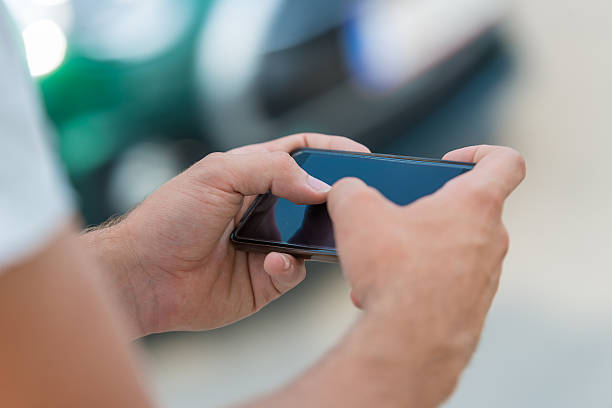 istock Close up of a man using mobile smart phone 611080210