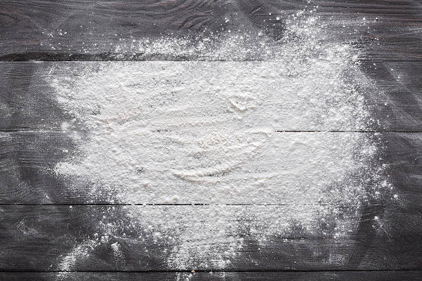 Baking concept on wood background, sprinkled flour with copy space Baking class or recipe concept on dark background, sprinkled wheat flour with free text copy space. Baking preparation, top view on wooden board or table. Cooking dough or pastry. flour stock pictures, royalty-free photos & images