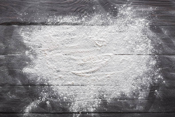 Baking concept on wood background, sprinkled flour with copy space Baking class or recipe concept on dark background, sprinkled wheat flour with free text copy space. Baking preparation, top view on wooden board or table. Cooking dough or pastry. wholegrain flour stock pictures, royalty-free photos & images