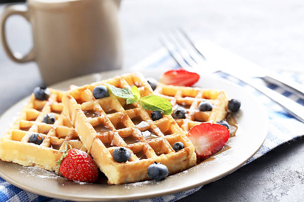 istock Homemade waffles with berries in plate on grey table 611080770