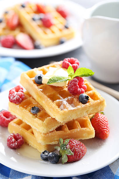 istock Homemade waffles with berries in plate on grey table 611080936