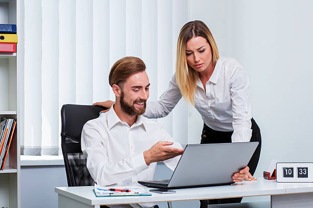 istock man and woman discussing a working project 611081096