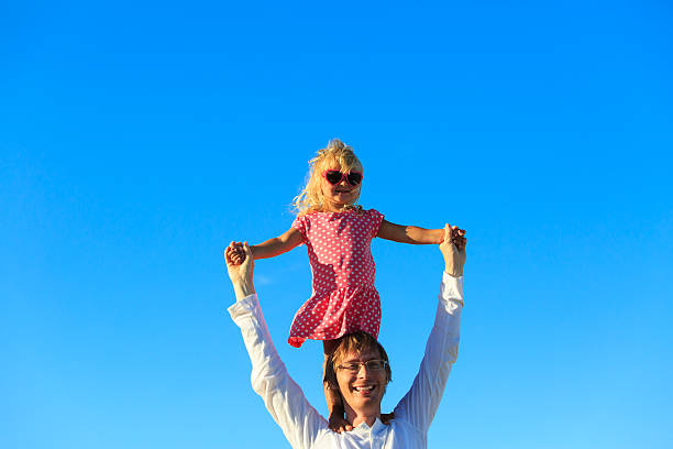 istock Father and little daughter play at sky 611082044