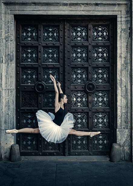istock Ballet dancer jumping in the street 611083078