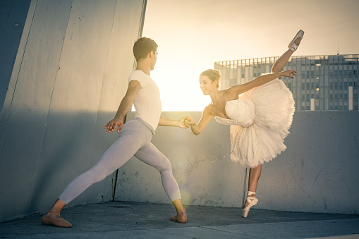 Ballet dancers performing in the city at sunset