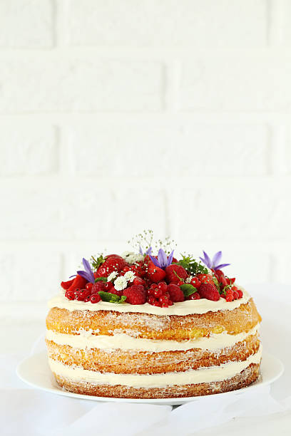 istock Delicious biscuit cake with berries on brick wall background 611083296