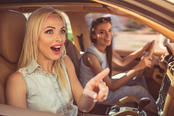 istock Girls driving the car 611083450