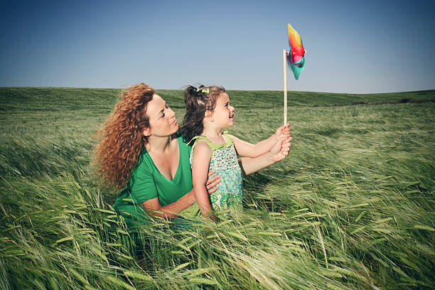mother and child playing with toy windmill