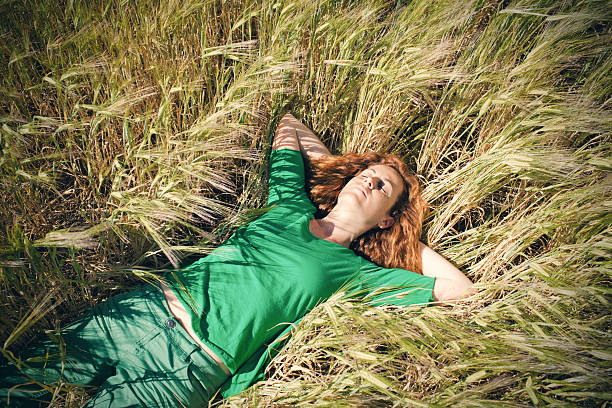 istock Woman resting in barley field 611085138