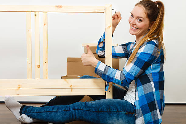 istock Woman assembling wooden furniture. DIY. 611085308