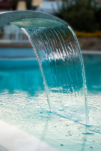 Pouring water on the swimming pool in Greece.