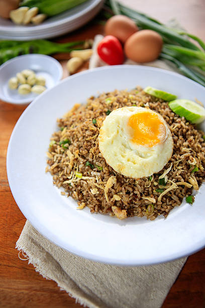istock Indonesia Nasi Goreng fried rice with egg on white plate 611086184
