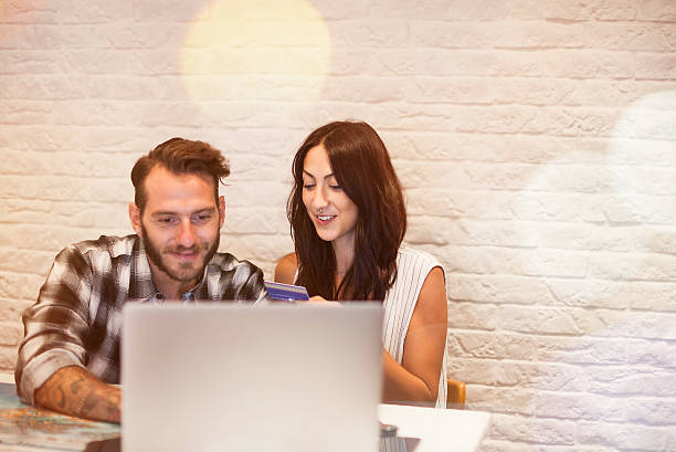 istock Young couple in love planning a trip with laptop 611086666