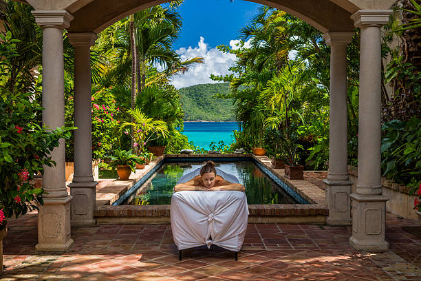 woman receiving a massage at a beautiful villa in Caribbean woman receiving a massage at a beautiful villa on St John, United States Virgin Islands st john's plant stock pictures, royalty-free photos & images
