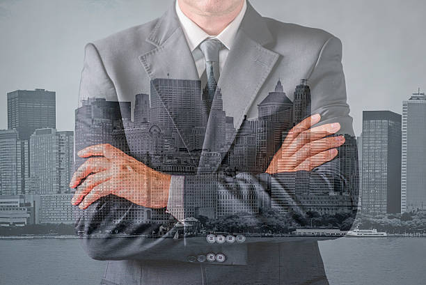 istock man wearing business suit and black tie with arms crossed 611088198