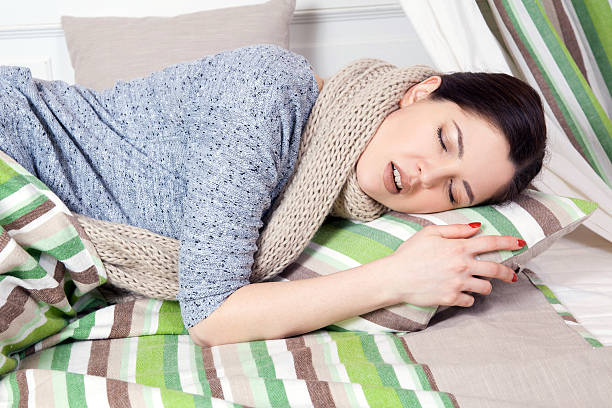 istock Sick woman with temperature resting. 611089246