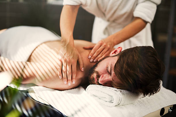 Man having back massage at the health  spa. stock photo