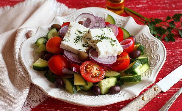 istock Greek salad on red background 611091482
