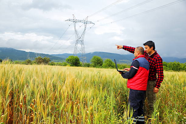 istock Two Farmer with laptop in wheat field 611091748