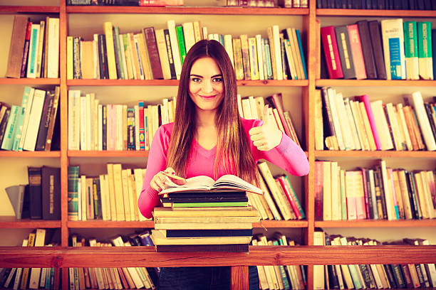 istock Content girl student in college library 611092680
