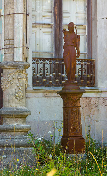 istock Rusty old statue of a woman 611093604
