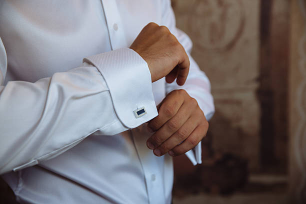 istock Groom hands with cufflinks. Elegant gentleman clother, white shirt 611093792