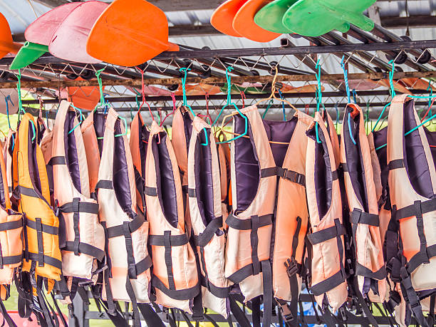 istock Orange life jackets and colorful paddles for services 611095960
