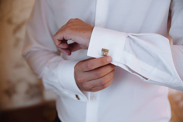 istock Groom hands with cufflinks. Elegant gentleman clother, white shirt 611096024