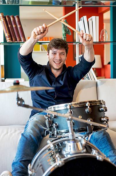 istock Man Playing Drums in Living-room 611096746