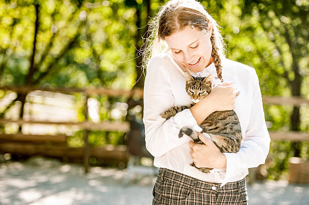 istock Young Woman Portrait with her Cat 611096784