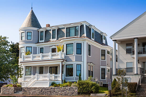 House with Grey Clapboard in Portland, Maine, New England, USA. Portland, ME, USA - September 17, 2013: House with Grey Clapboard in Portland, Maine, New England, USA. Green trees, bushes and clear blue sky are in the image.  Canon EF 24-105mm f/4 L IS lens. Polarizing filter. driveway colonial style house residential structure stock pictures, royalty-free photos & images