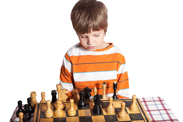 istock Portrait of a little boy playing chess 611097696